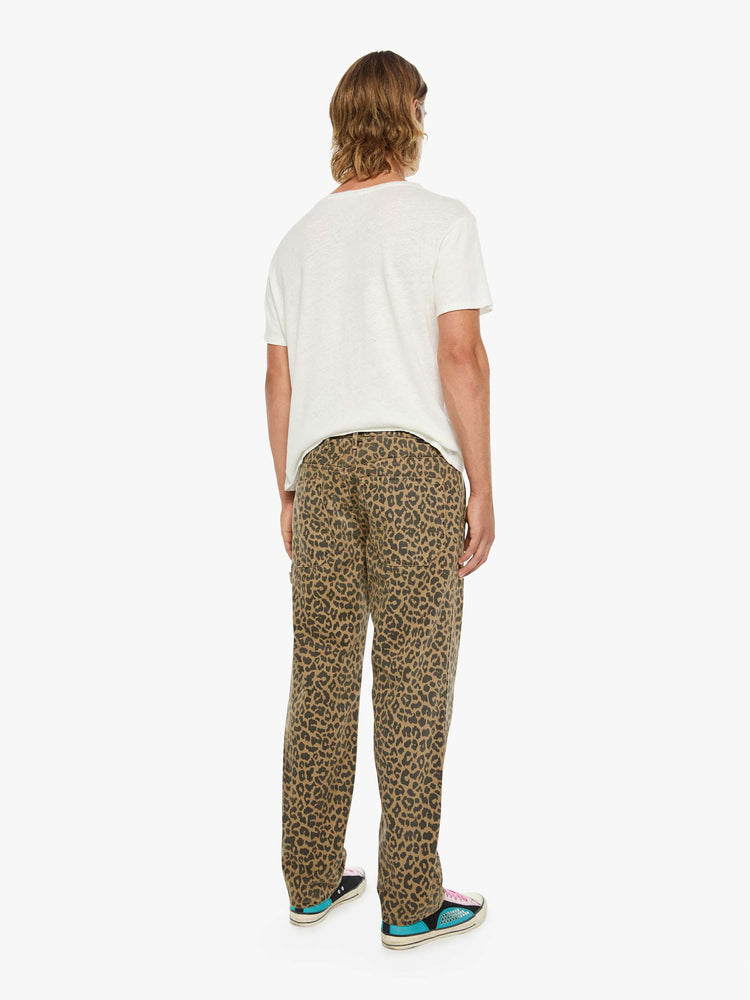Back view of a man in a leopard print classic pant with patch pockets, a zip fly, hammer loop and loose leg.