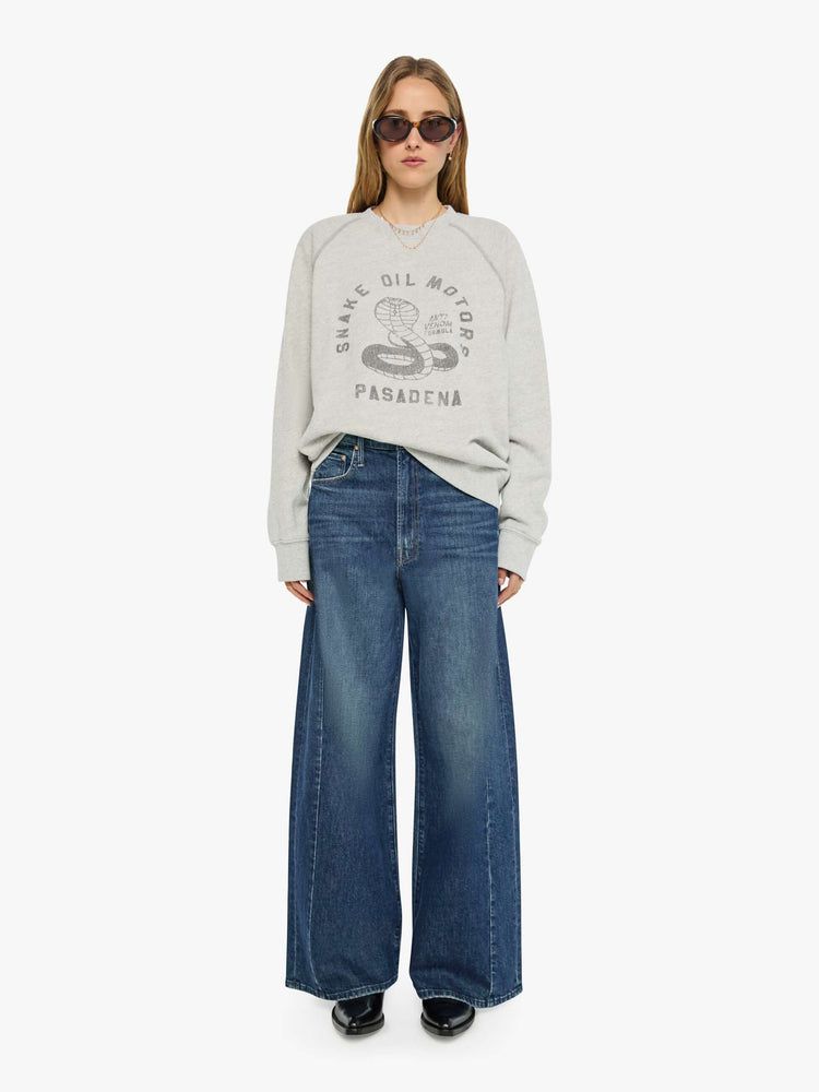 WOMAN front full view heathered light grey sweatshirt features a faded snake graphic and block text on the front.