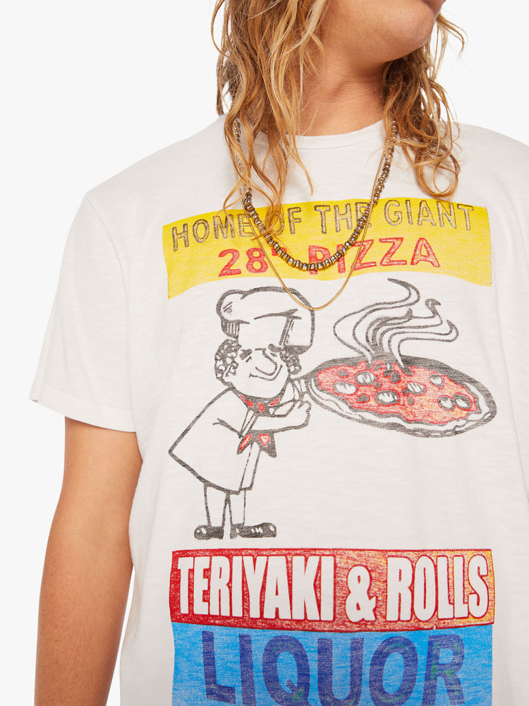 Close up view of a mens classic crewneck tee with short sleeves and a boxy fit in white with colorful graphic inspired by pizza shop.