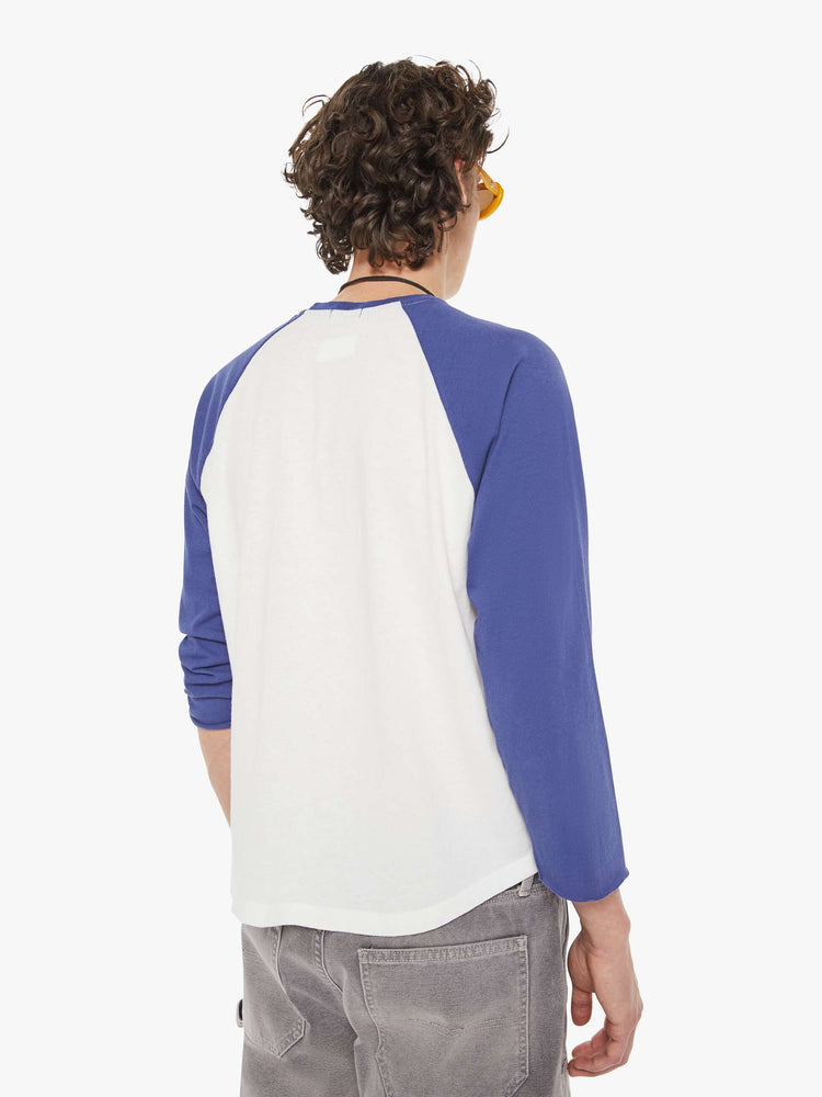 MEN back view in a  baseball tee with a crew neck, 3/4-length frayed sleeves and a curved hem in white with blue sleeves and a red demolition derby graphic on the front.