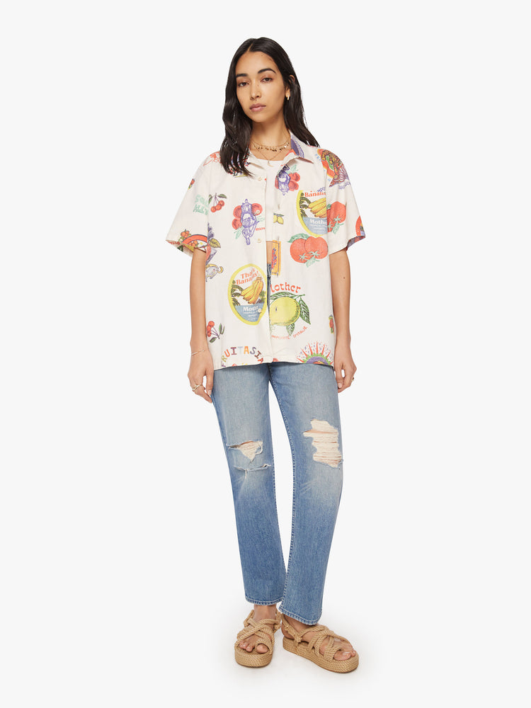WOMEN full body view short sleeve button-up with a patch pocket and slightly cropped hem in off white color with images of fruit labels.