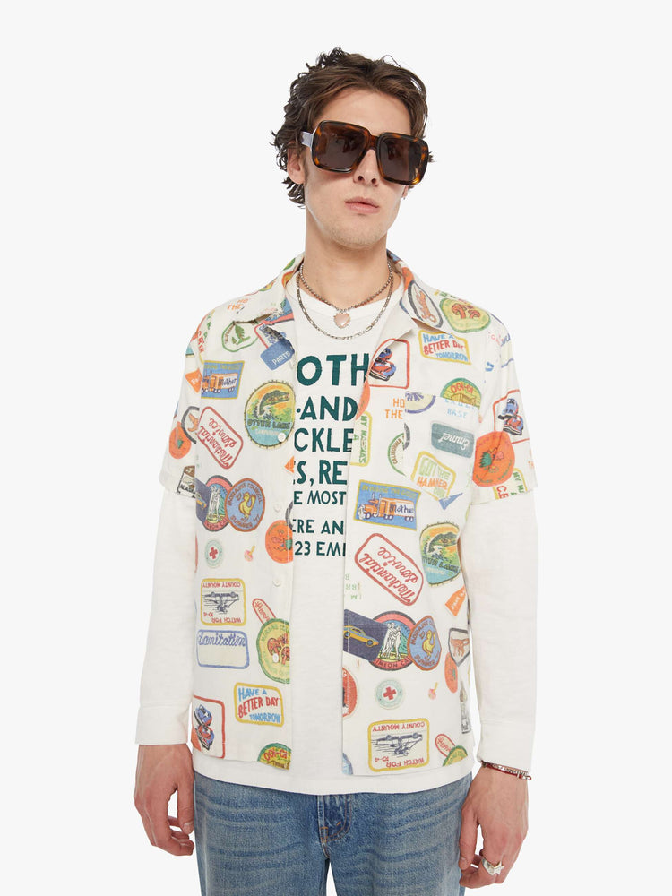 MEN front view of an off-white with faded patches printed throughout short sleeve button-up with a patch pocket.