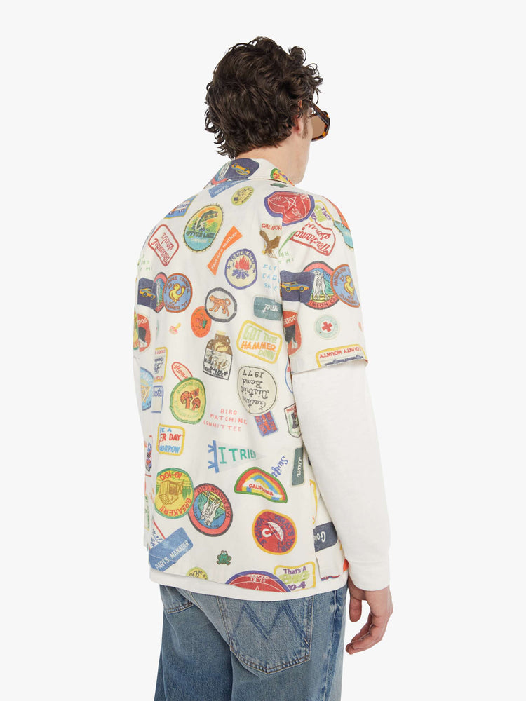 MEN back view of an off-white with faded patches printed throughout short sleeve button-up with a patch pocket.