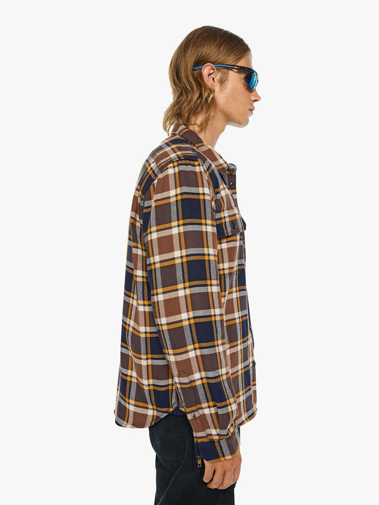 Side view of a man in black, brown, yellow collared button-up with patch pockets, long sleeves and a classic fit.