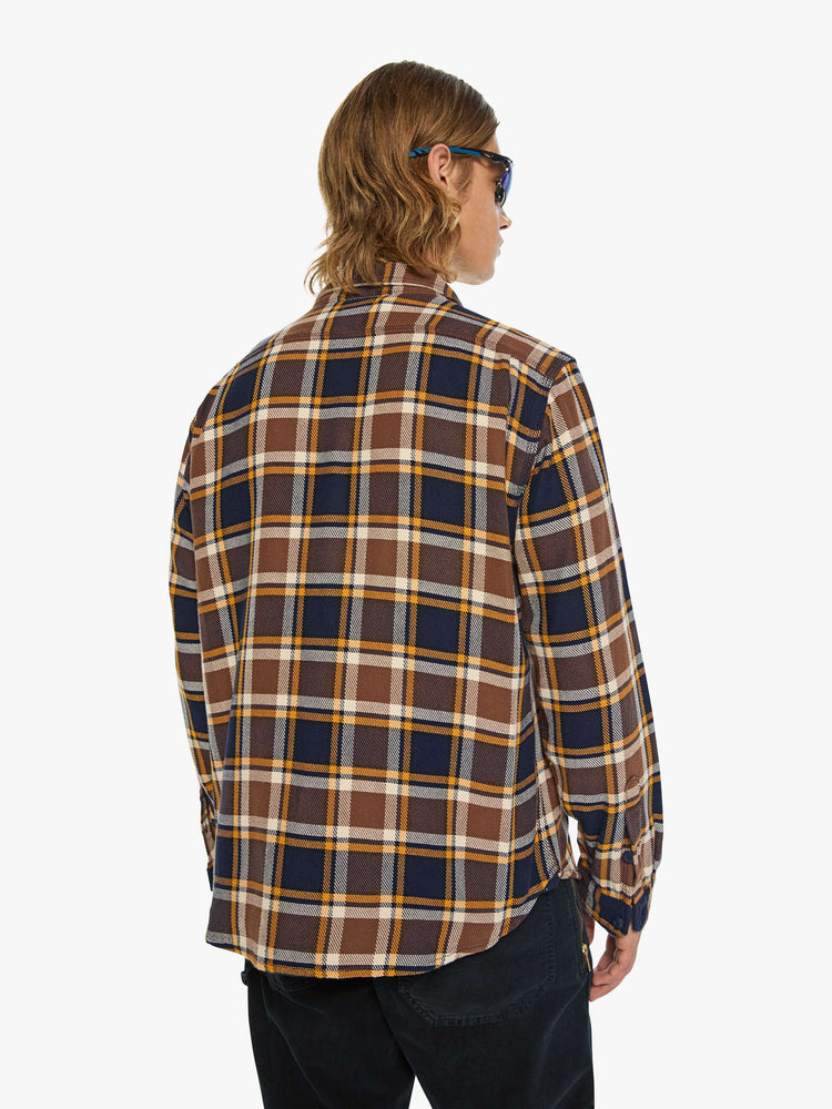 Back view of a man in black, brown, yellow collared button-up with patch pockets, long sleeves and a classic fit.