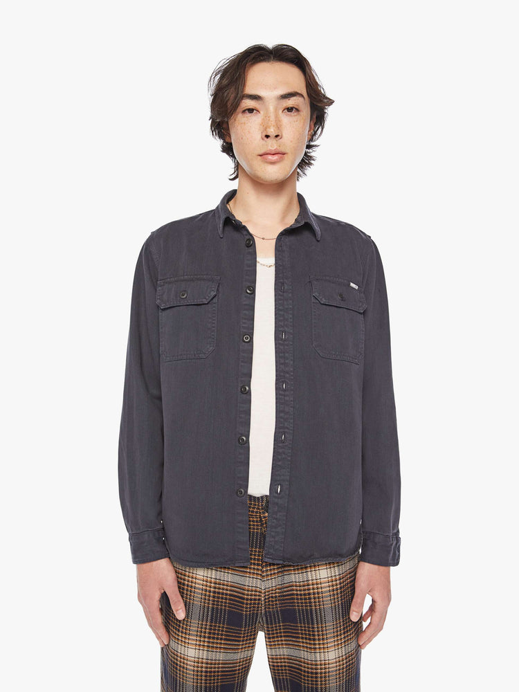 Front view of a mens classic button-up shirt with double patch pockets, long sleeves and a curved hem in a faded black hue.