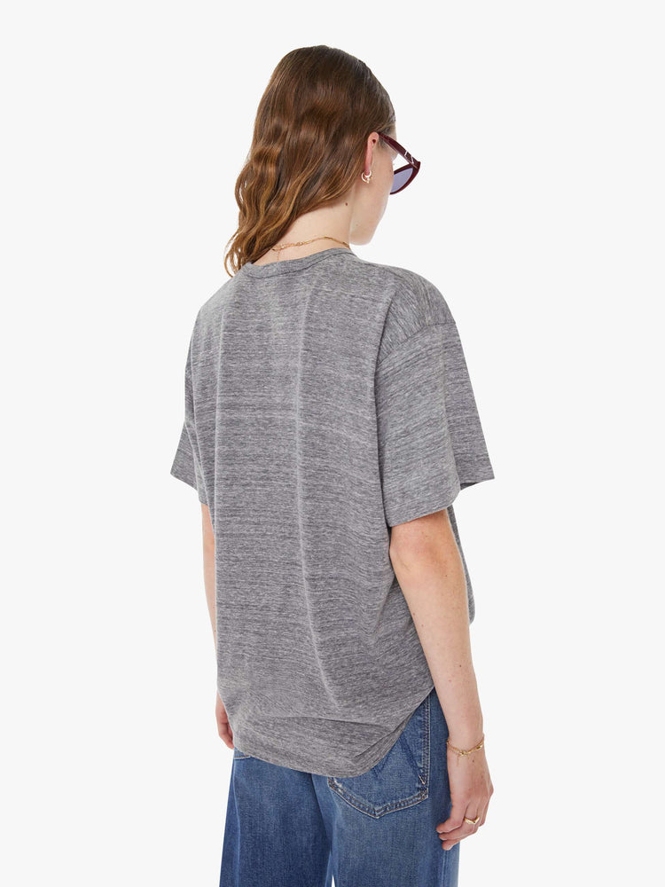 WOMAN back view in an oversized tee in heathered grey, the tee features a firecracker graphic in red and black on the front.