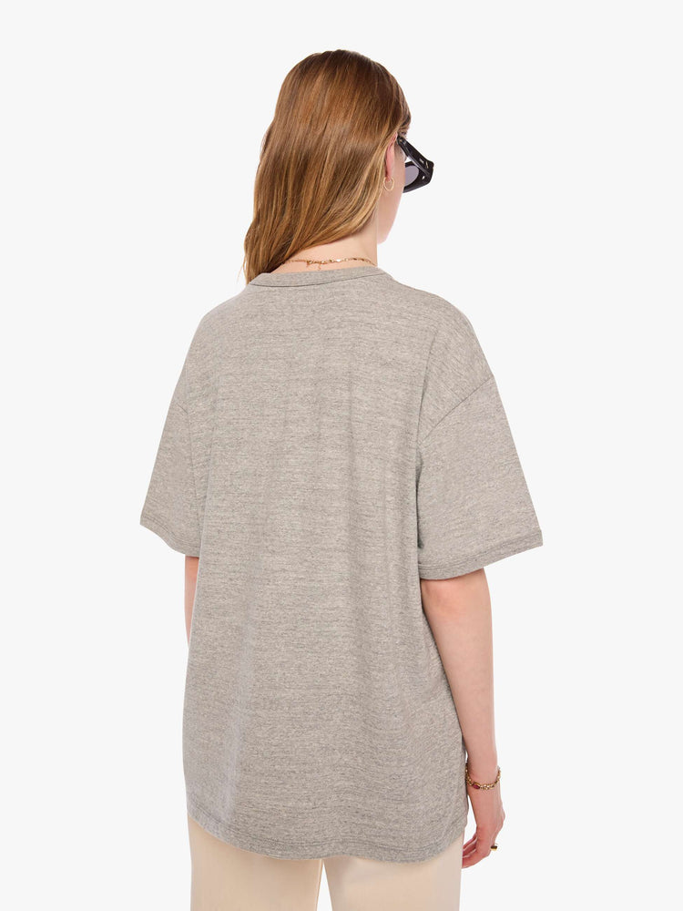 WOMAN back view in heathered grey tee with a faded red and blue text graphic on the front inspired by a vintage cookoff.