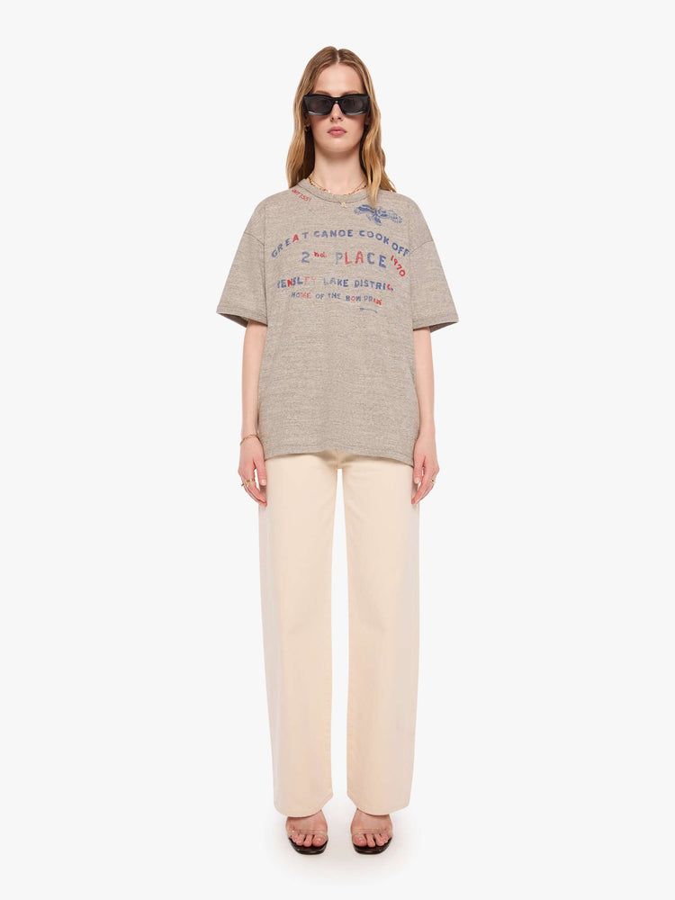 WOMAN front full body view in heathered grey tee with a faded red and blue text graphic on the front inspired by a vintage cookoff.