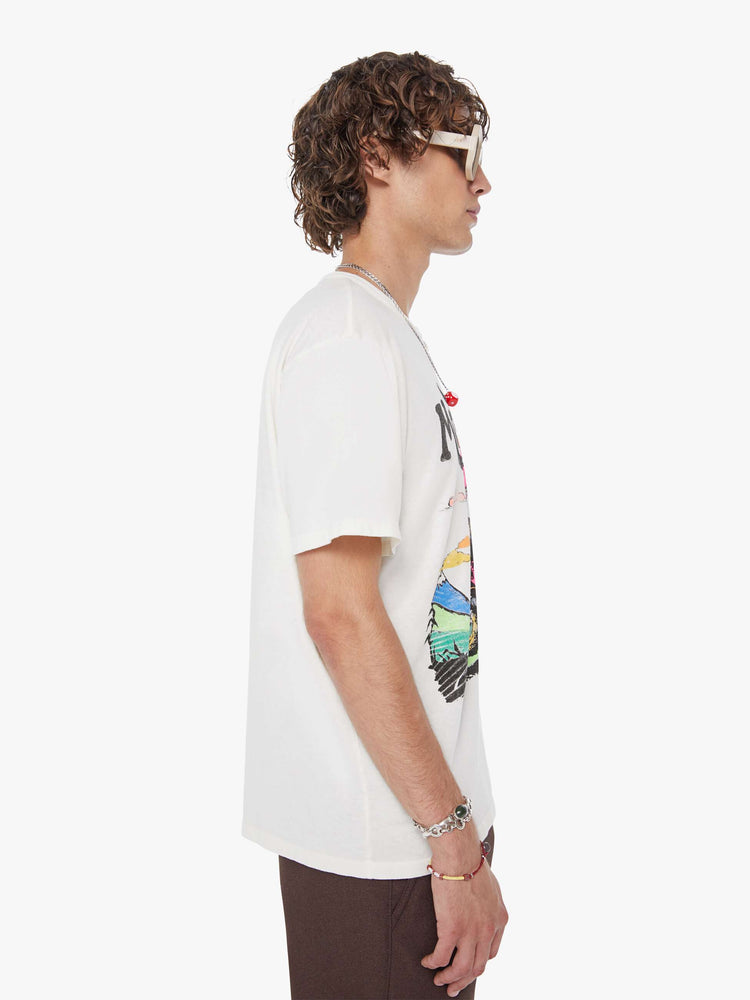 MEN side view in white oversized tee features a faded biker graphic and MOTHER's name in black on the front.