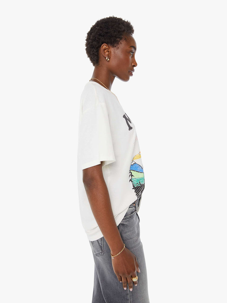 WOMAN side view in white oversized tee features a faded biker graphic and MOTHER's name in black on the front.