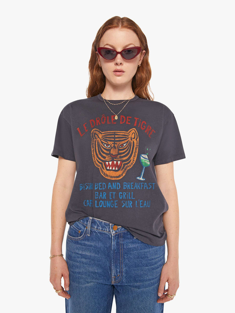 WOMAN front view of an oversized tee in faded black with a tiger graphic with text in red and blue on front.