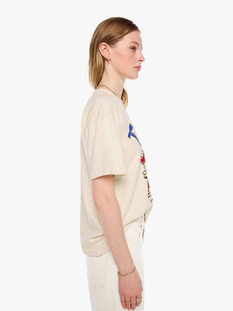 WOMAN side view in a cream tee features a vintage-inspired butcher-shop graphic on the front.
