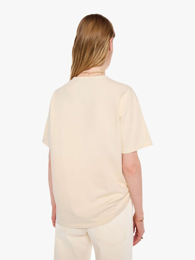 WOMAN back view in a cream tee features a vintage-inspired butcher-shop graphic on the front.