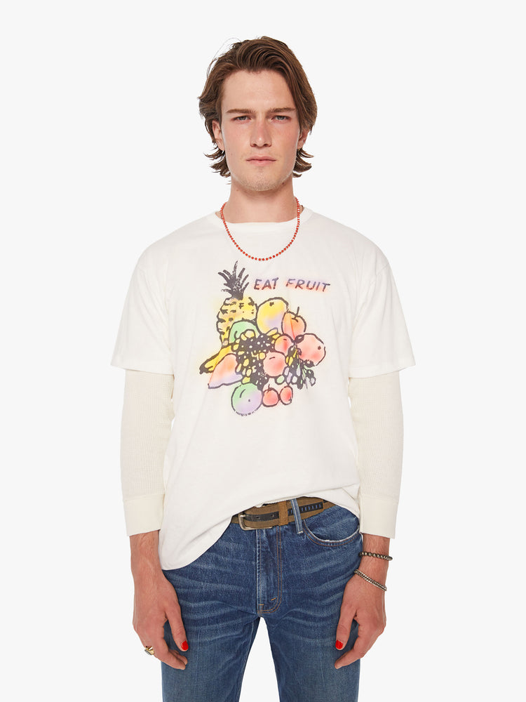 Front view of a men oversized tee with drop shoulders in white and the tee features a colorful fruit graphic and text on the front.