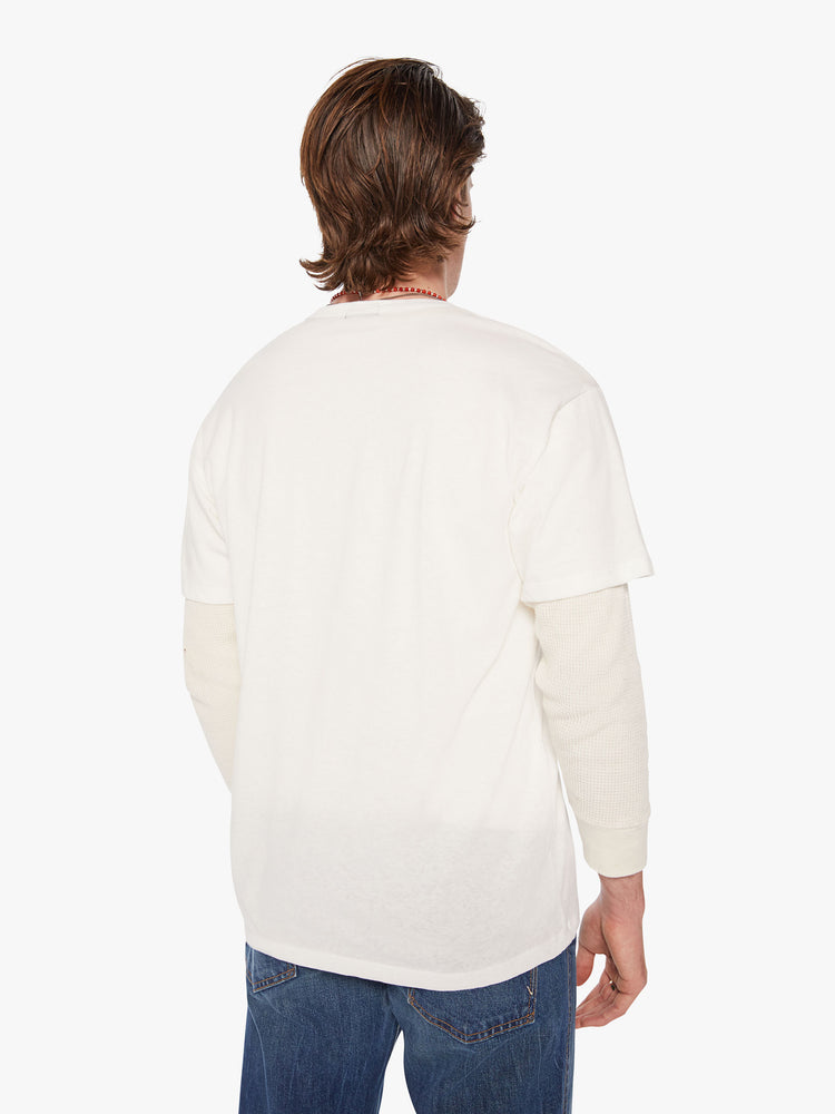 Back view of a men oversized tee with drop shoulders in white and the tee features a colorful fruit graphic and text on the front.