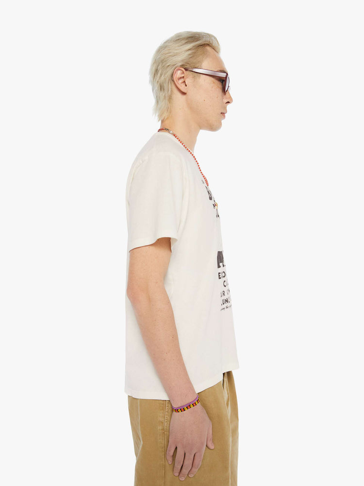 MEN side view of an oversized tee in off-white with a faded black graphic inspired by a Lake Tahoe club.