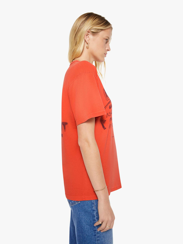 WOMAN side view in a red with fading throughout oversized tee features a faded graphic inspired by a vintage sporting goods store on the front.