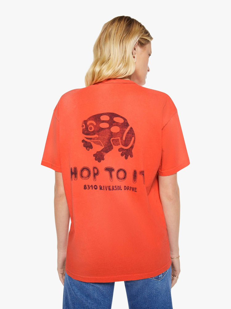 WOMAN back view in a red with fading throughout oversized tee features a faded graphic inspired by a vintage sporting goods store on the front.
