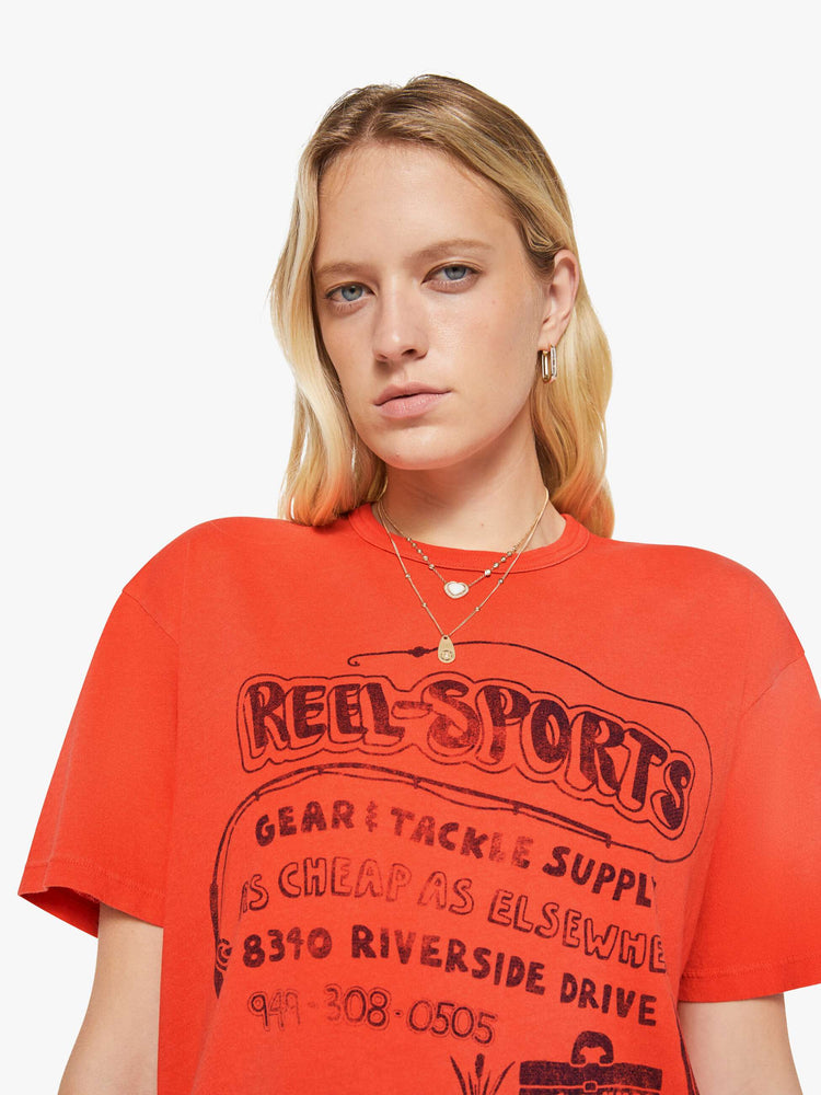 WOMAN front close up view in a red with fading throughout oversized tee features a faded graphic inspired by a vintage sporting goods store on the front.