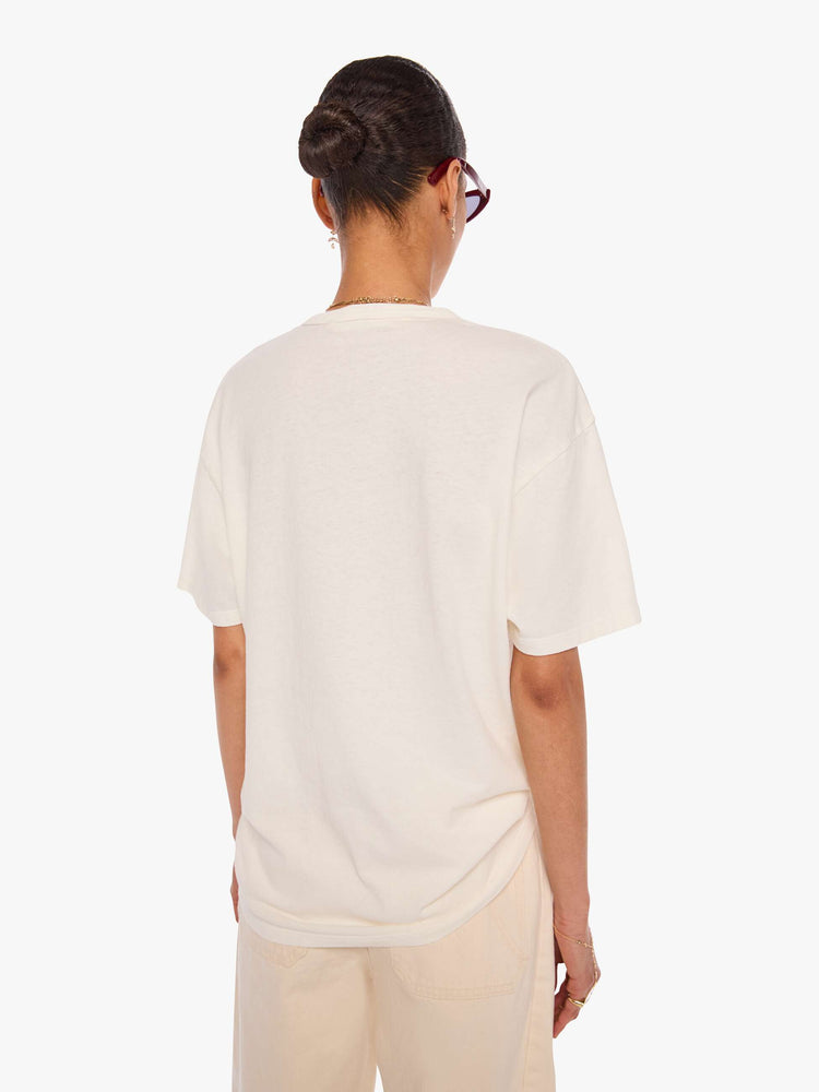 WOMAN back view in a off-white tee with a faded graphic on the front inspired by a vintage contractor's event tee.