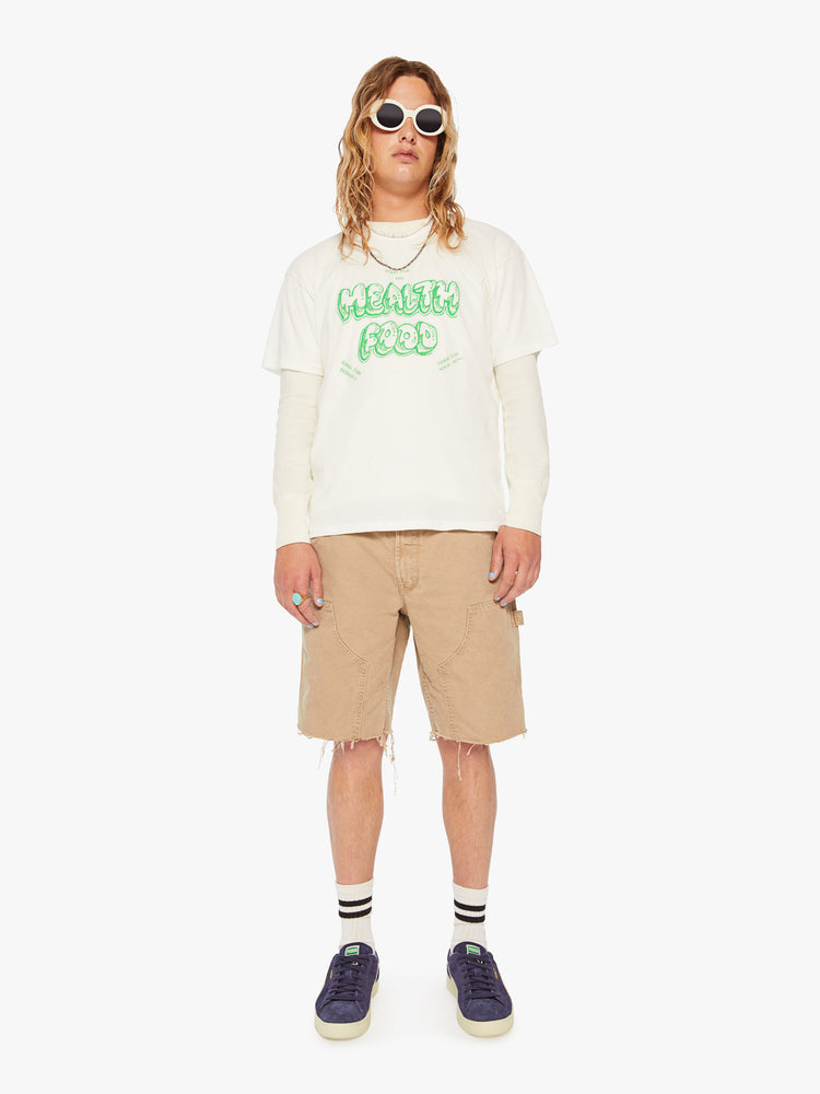Full body view of a men off-white oversized tee with drop shoulders with lime green text.