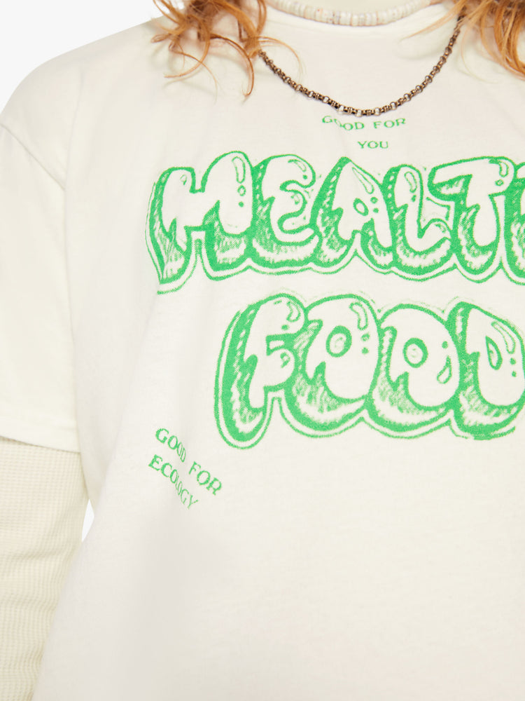Close up view of a men off-white oversized tee with drop shoulders with lime green text.