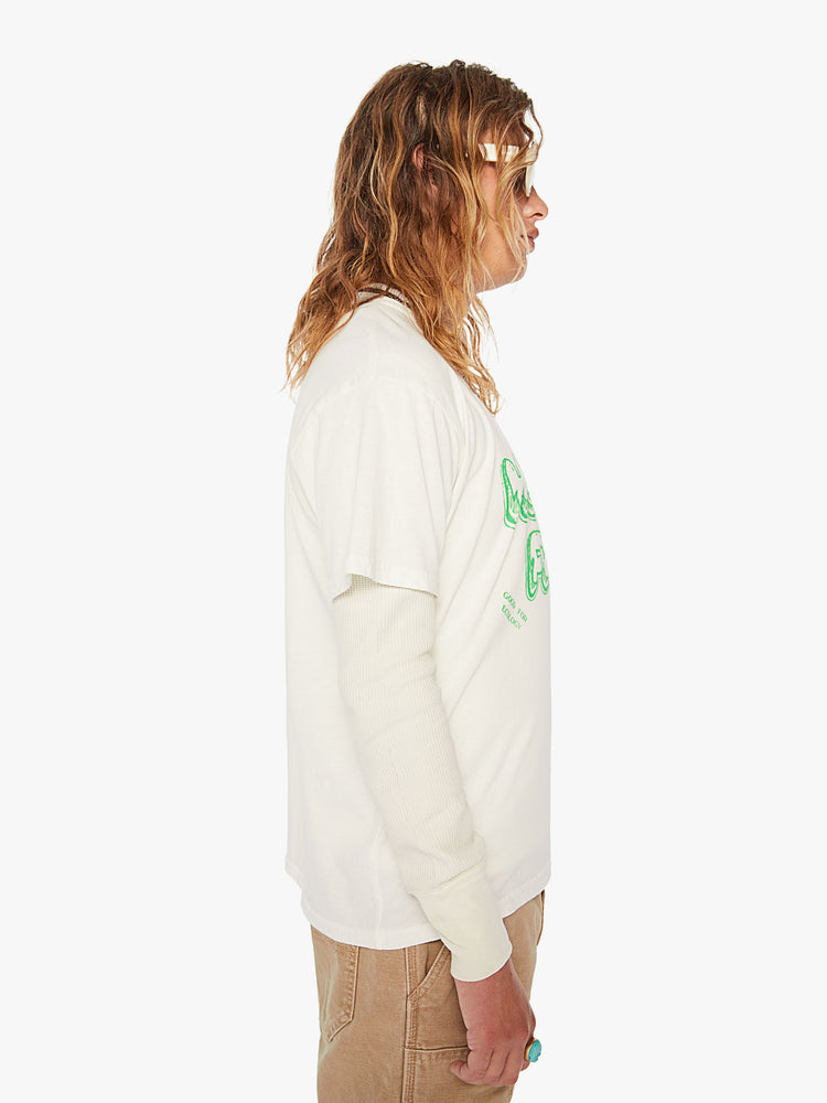 Side view of a men off-white oversized tee with drop shoulders with lime green text.