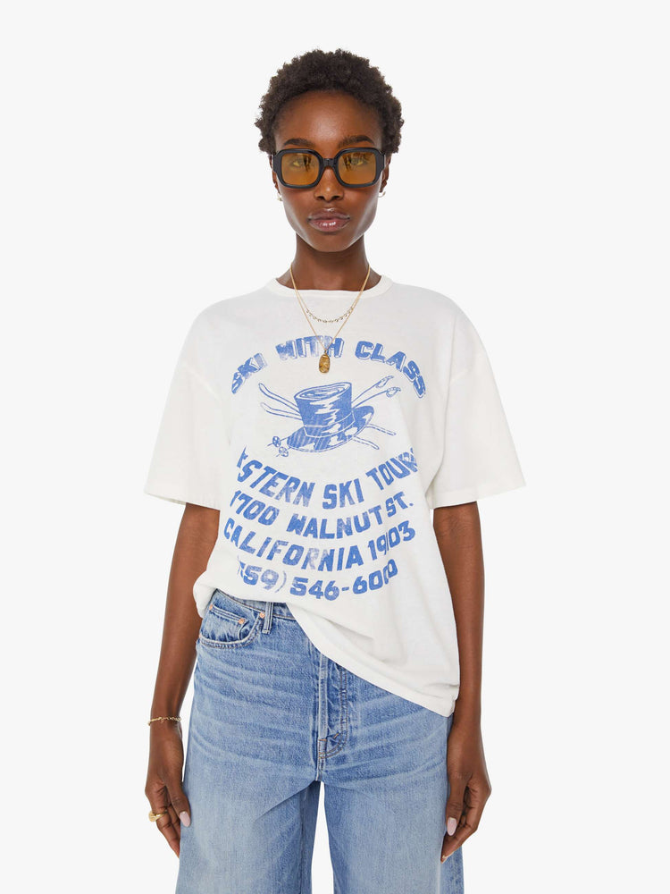 WOMAN front view in a white tee features a faded graphic inspired by a retro ski school on the front.