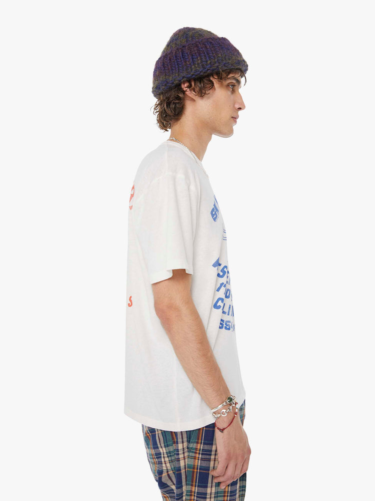 MEN side view in a white tee features a faded graphic inspired by a retro ski school on the front.