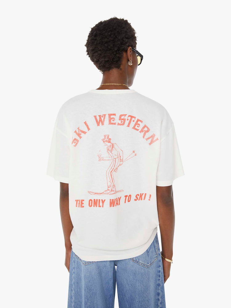 WOMAN back view in a white tee features a faded graphic inspired by a retro ski school on the front.