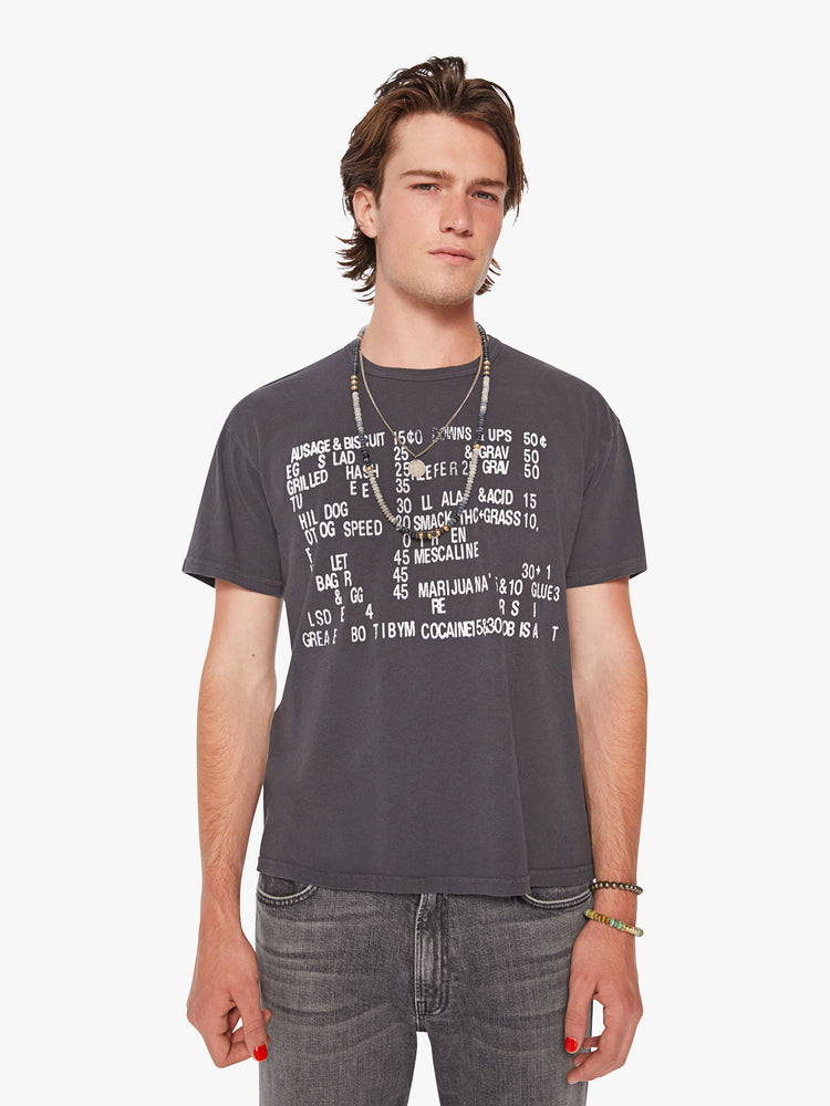 Front view of a men oversized tee with drop shoulders and a loose fit in a dark grey hue with a menu of illicit substances on the front.
