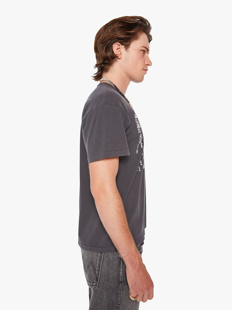 Side view of a men oversized tee with drop shoulders and a loose fit in a dark grey hue with a menu of illicit substances on the front.