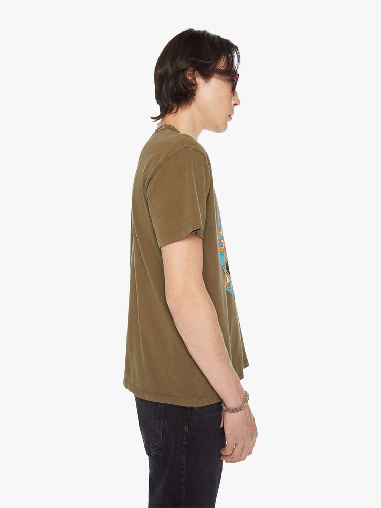Side view of a men olive-brown hue oversized tee with drop shoulders and a loose fit with a desert themed graphic.