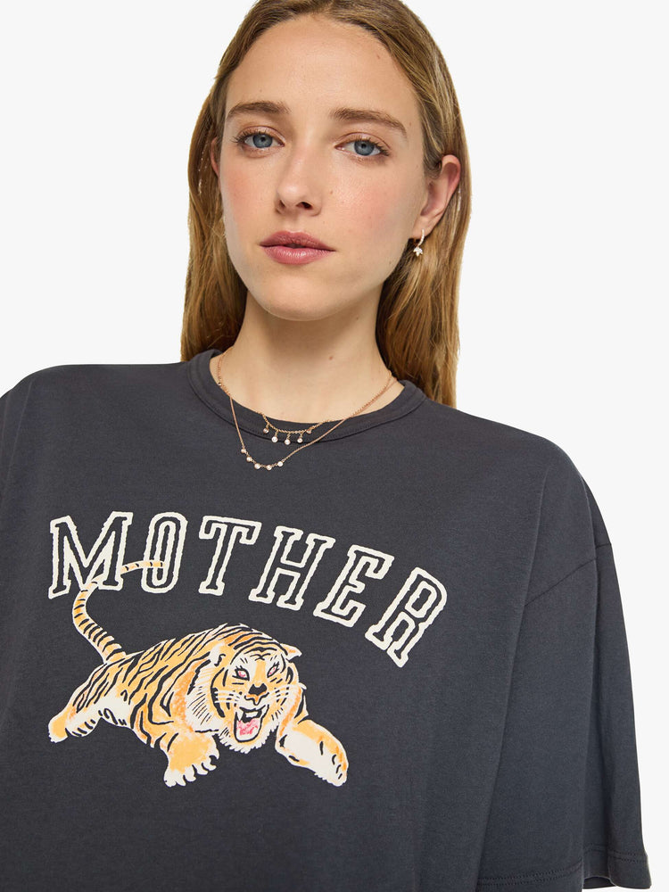 WOMAN close view in a dark grey tee features a tiger graphic and MOTHER's name in block text on the front.
