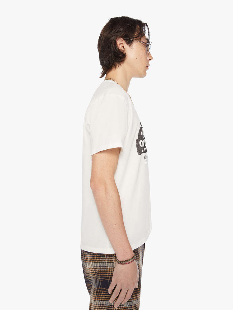 Side view of a men white with black graphic oversized tee with drop shoulders and a loose fit.
