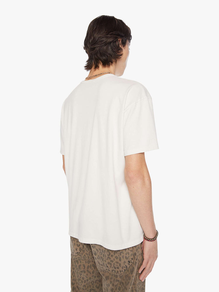 Side  view of a men white with faded red text oversized tee with drop shoulders and a loose fit.