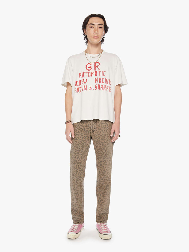 Full body  view of a men white with faded red text oversized tee with drop shoulders and a loose fit.