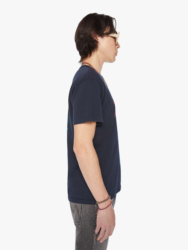 Side view of a men faded black oversized tee with drop shoulders and a loose fit.