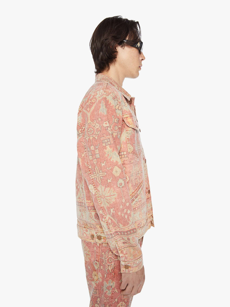 Side view of a men collared jacket with drop shoulders, patch pockets, slit pockets and a slightly shrunken fit in a faded tapestry inspired print.
