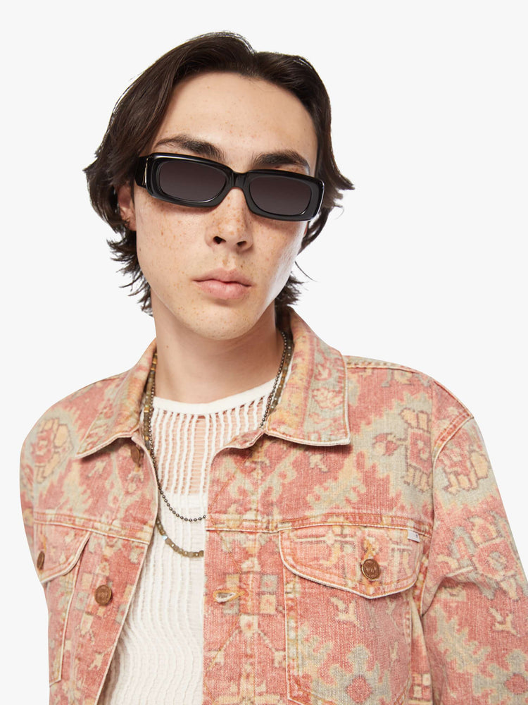 Close up view of a men collared jacket with drop shoulders, patch pockets, slit pockets and a slightly shrunken fit in a faded tapestry inspired print.