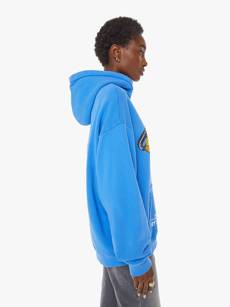 WOMAN side view of an oversized hoodie with drop shoulders, ribbed hems and a front patch pocket. 