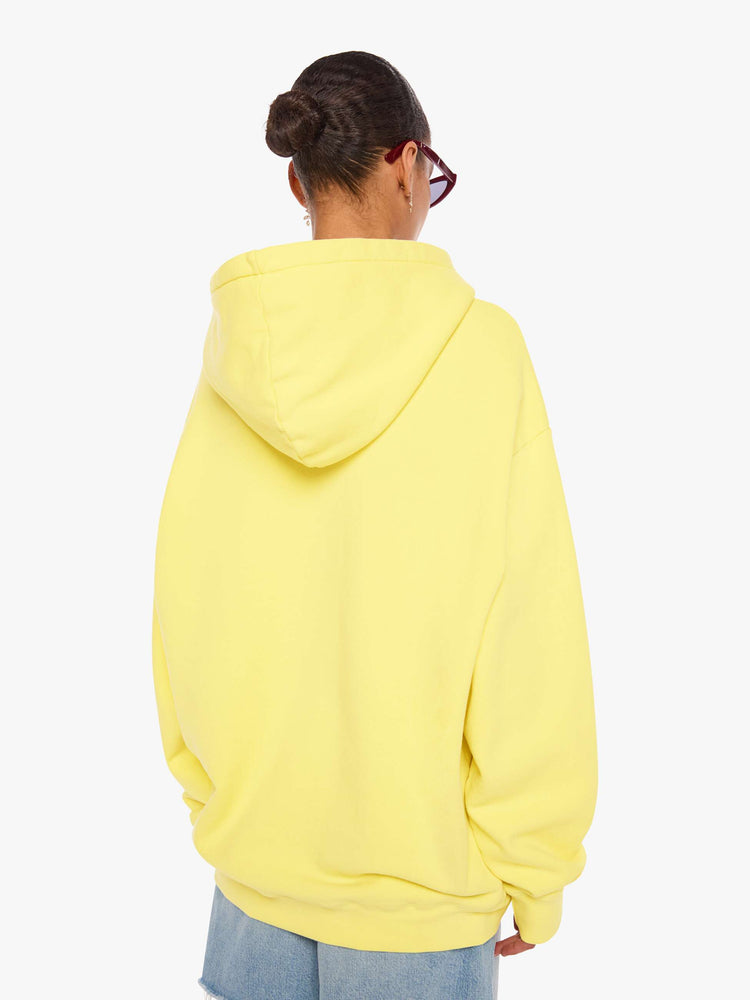 WOMAN back view of a yellow hoodie features MOTHER's name in dark grey across the front.