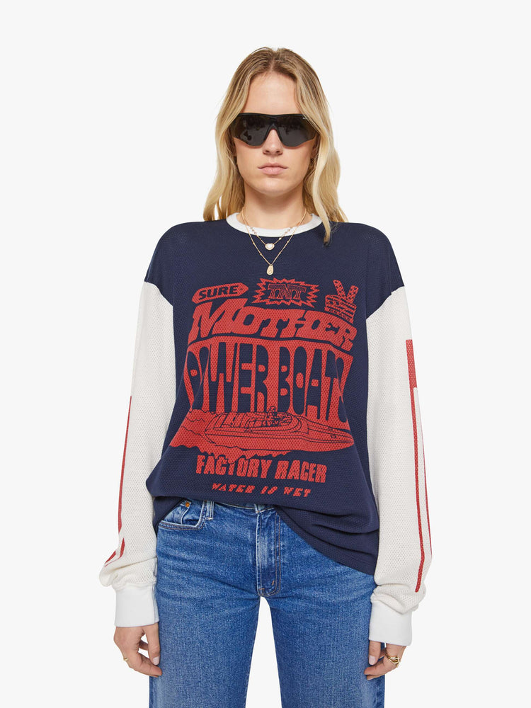 WOMAN Front view of a in navy with off-white sleeves, the tee features a text graphic in red on the front oversized long sleeve tee with drop shoulders and a loose fit.