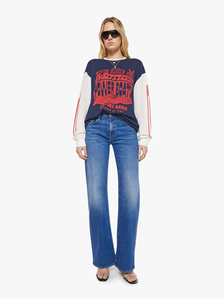 WOMAN Full body view of a in navy with off-white sleeves, the tee features a text graphic in red on the front oversized long sleeve tee with drop shoulders and a loose fit.