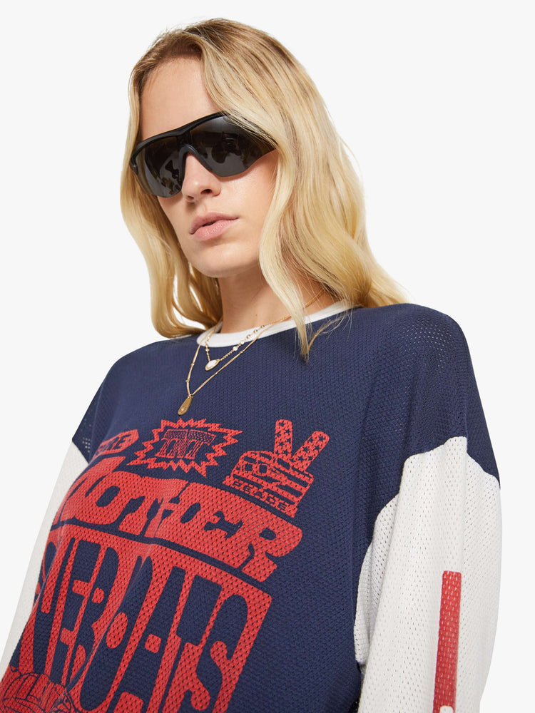WOMAN close up view of in a navy with off-white sleeves, the tee features a text graphic in red on the front oversized long sleeve tee with drop shoulders and a loose fit.