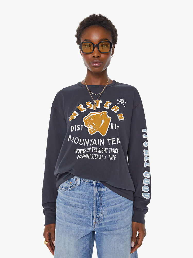 WOMAN front view of a faded black long sleeve tee features a yellow and white text graphic on the front inspired by a vintage mountaineering team shirt.