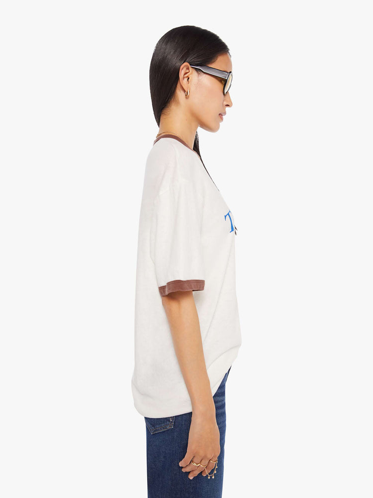 WOMEN side view of an oversized tee with drop shoulders and a loose fit in white with brown trim.