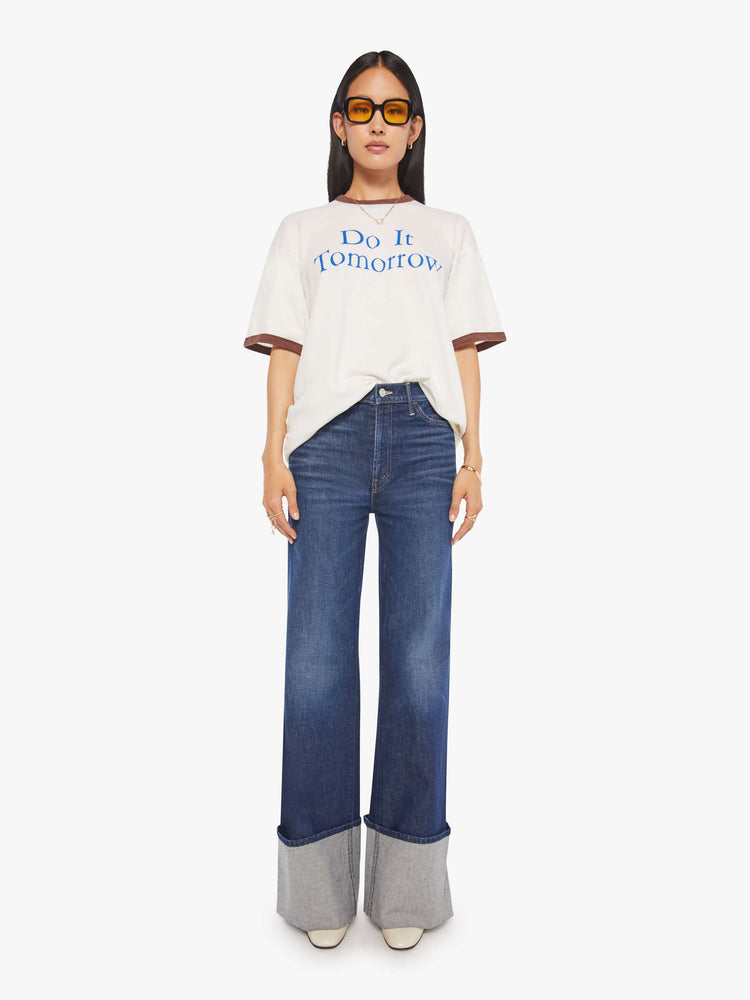 WOMEN full body view of an oversized tee with drop shoulders and a loose fit in white with brown trim.