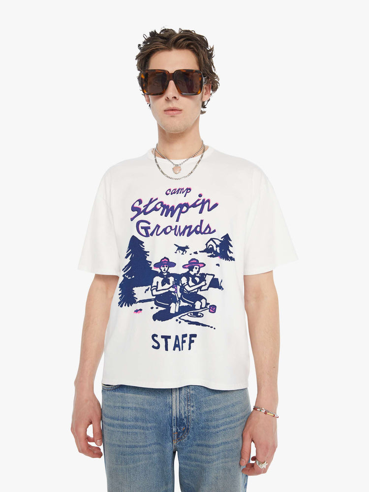 MEN front view in an oversized tee in white with hand-drawn graphic in blue and pink on the front inspired by a camp counselor tee.